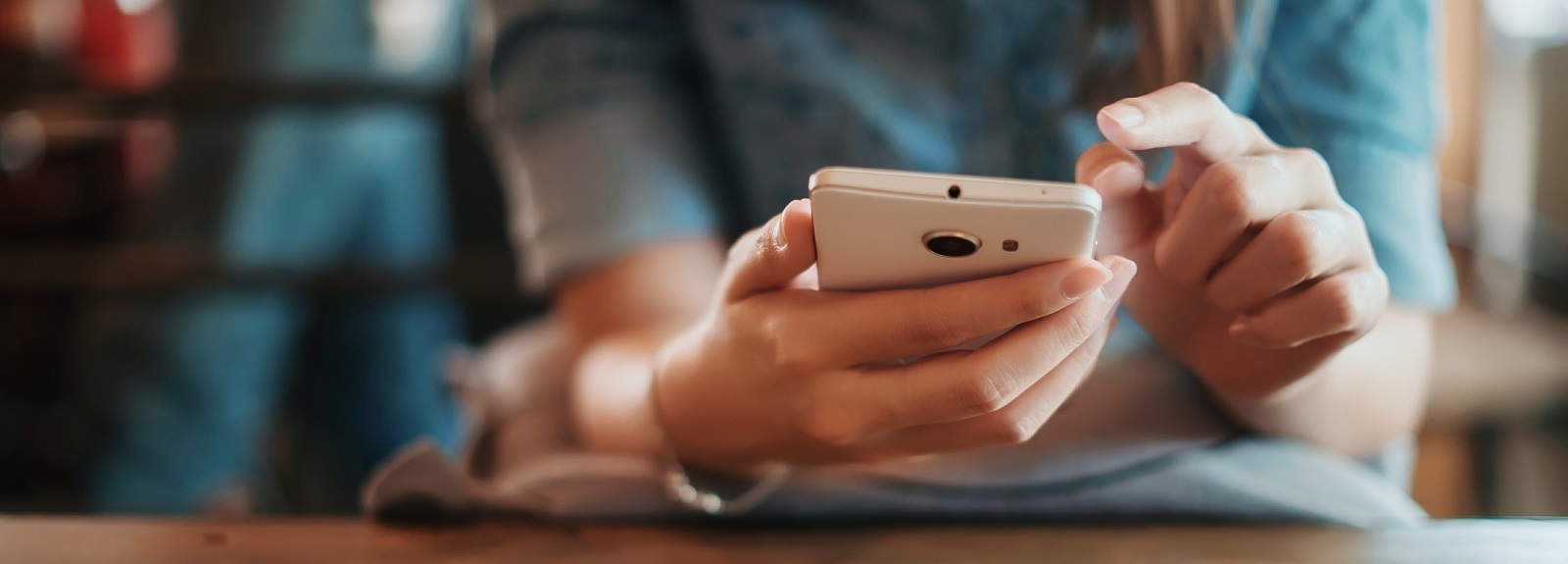 woman's hands using a smartphone