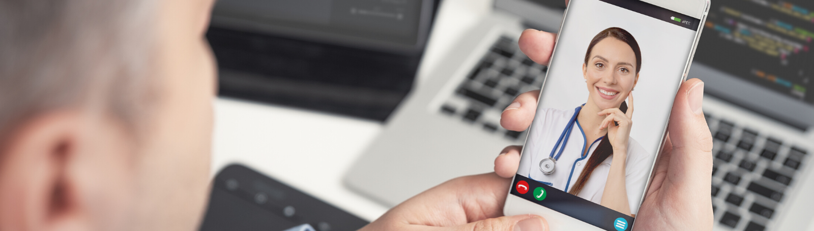 older man using phone for a VMG telehealth appointment