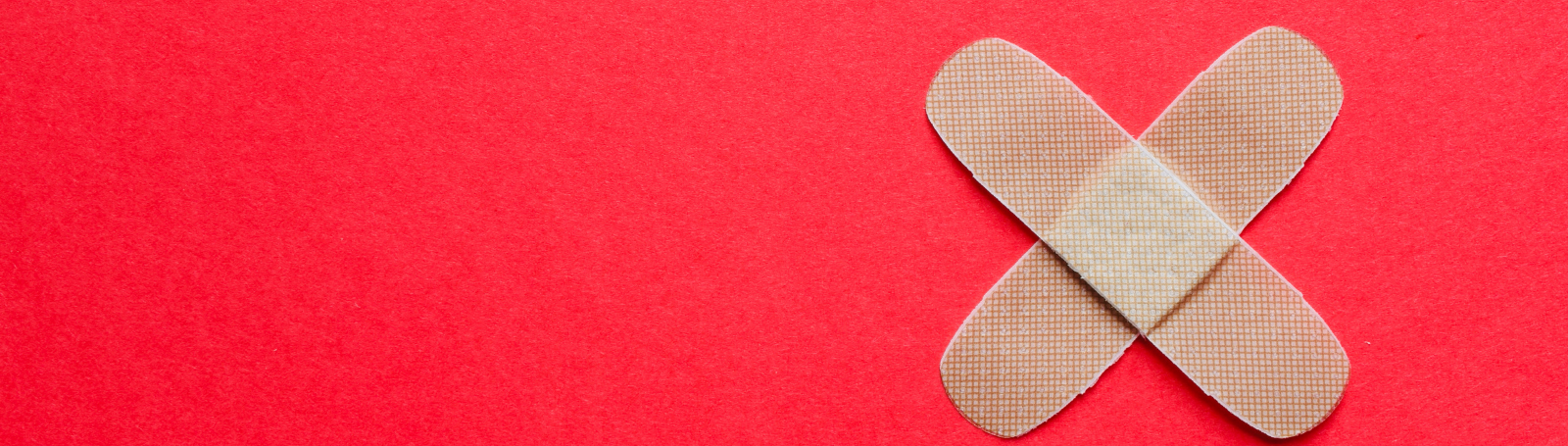 Two band-aids on a red background