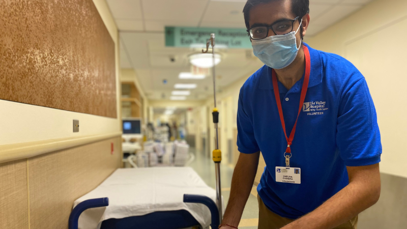 volunteer making patient bed