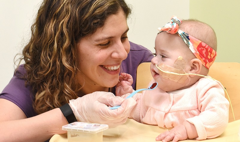 A baby receiving feeding therapy at the Kireker Center for Child Development