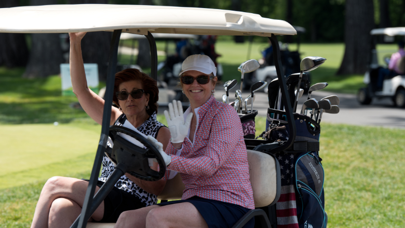 golf outing attendees in golf cart