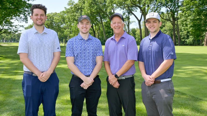 group of golfers posing for photo at golf outing event