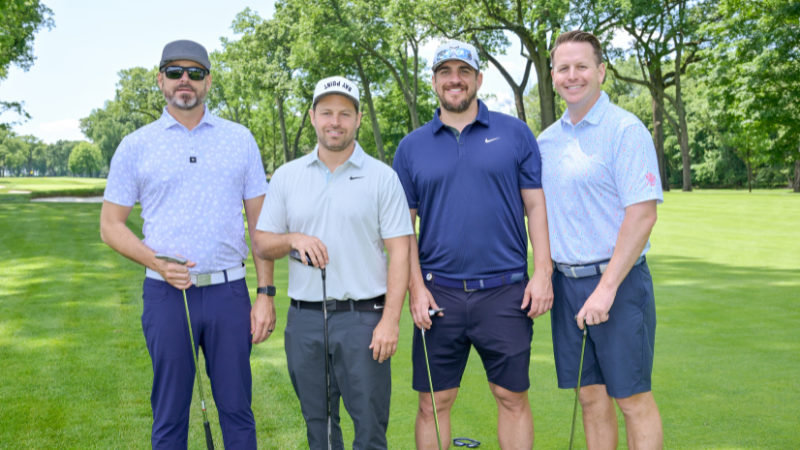 group of golfers posing for photo at golf outing event