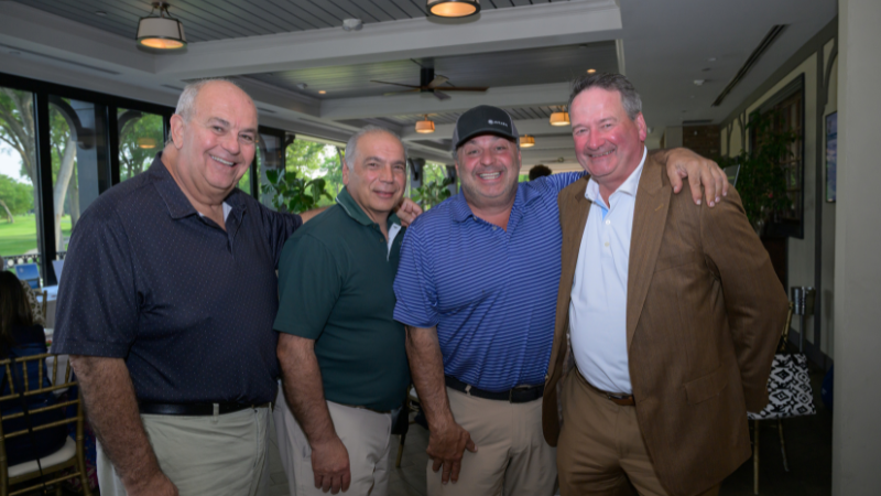 group of people posing for photo at golf outing event