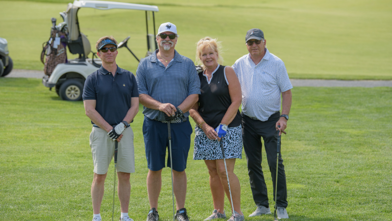 group of golfers posing for photo at golf outing event