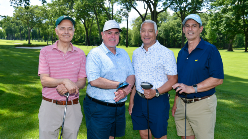 group of golfers posing for photo at golf outing event