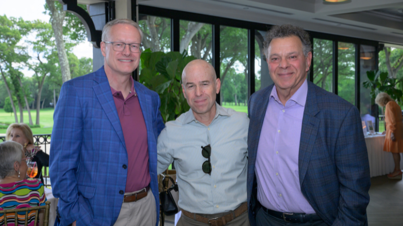 group of people posing for photo at golf outing event