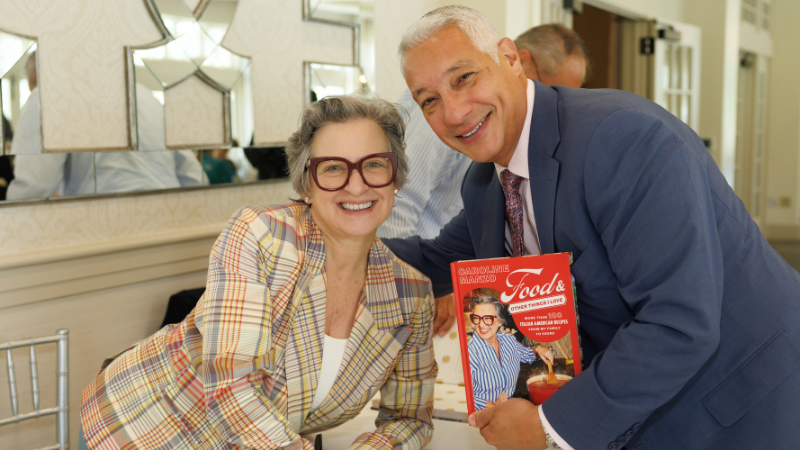 caroline manzo and joe lorino posing for a photo with book