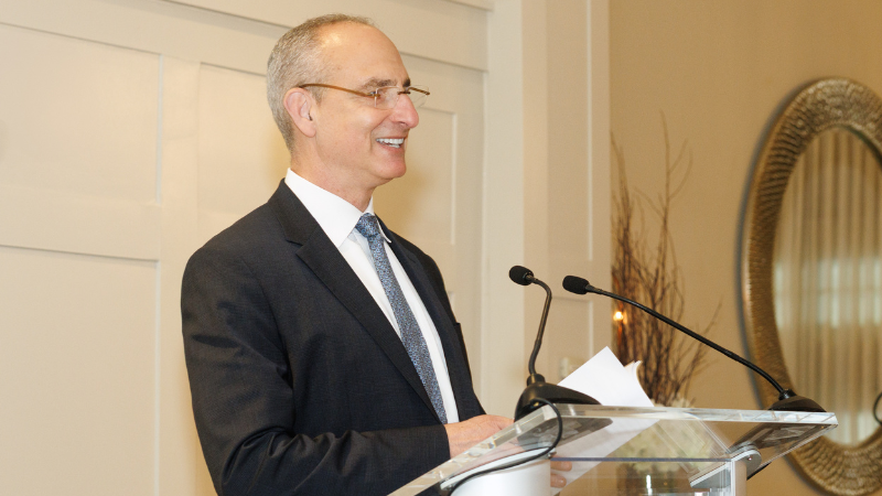CEO Robert Brenner standing at podium speaking