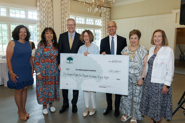 group of people holding pledge check at reception
