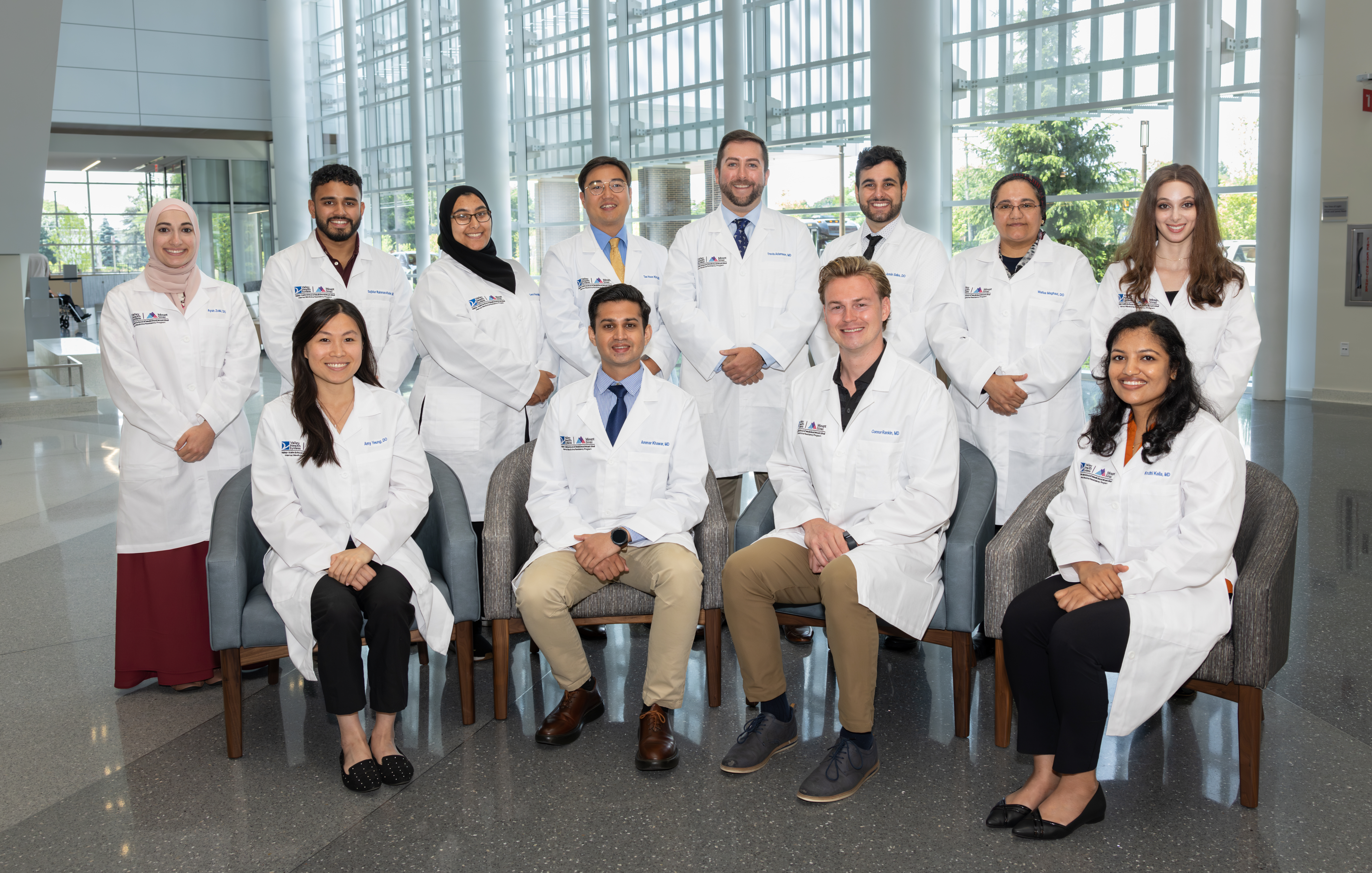 group of internal medicine resident doctors standing in the lobby of the hospital