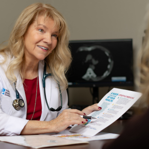 Cardiologist smiling and reviewing results with a patient.