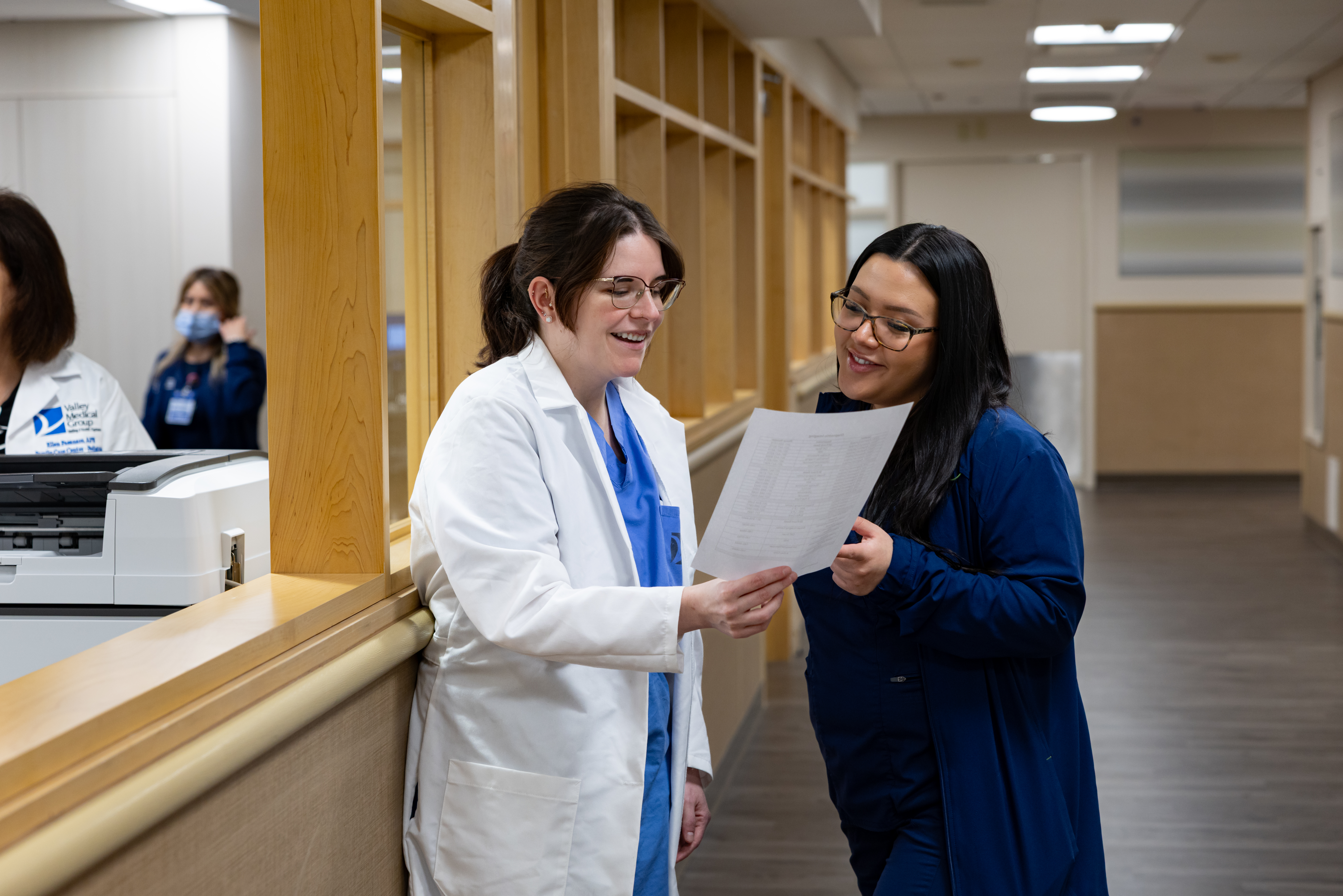 A resident physician consulting with staff at the Family Care Center