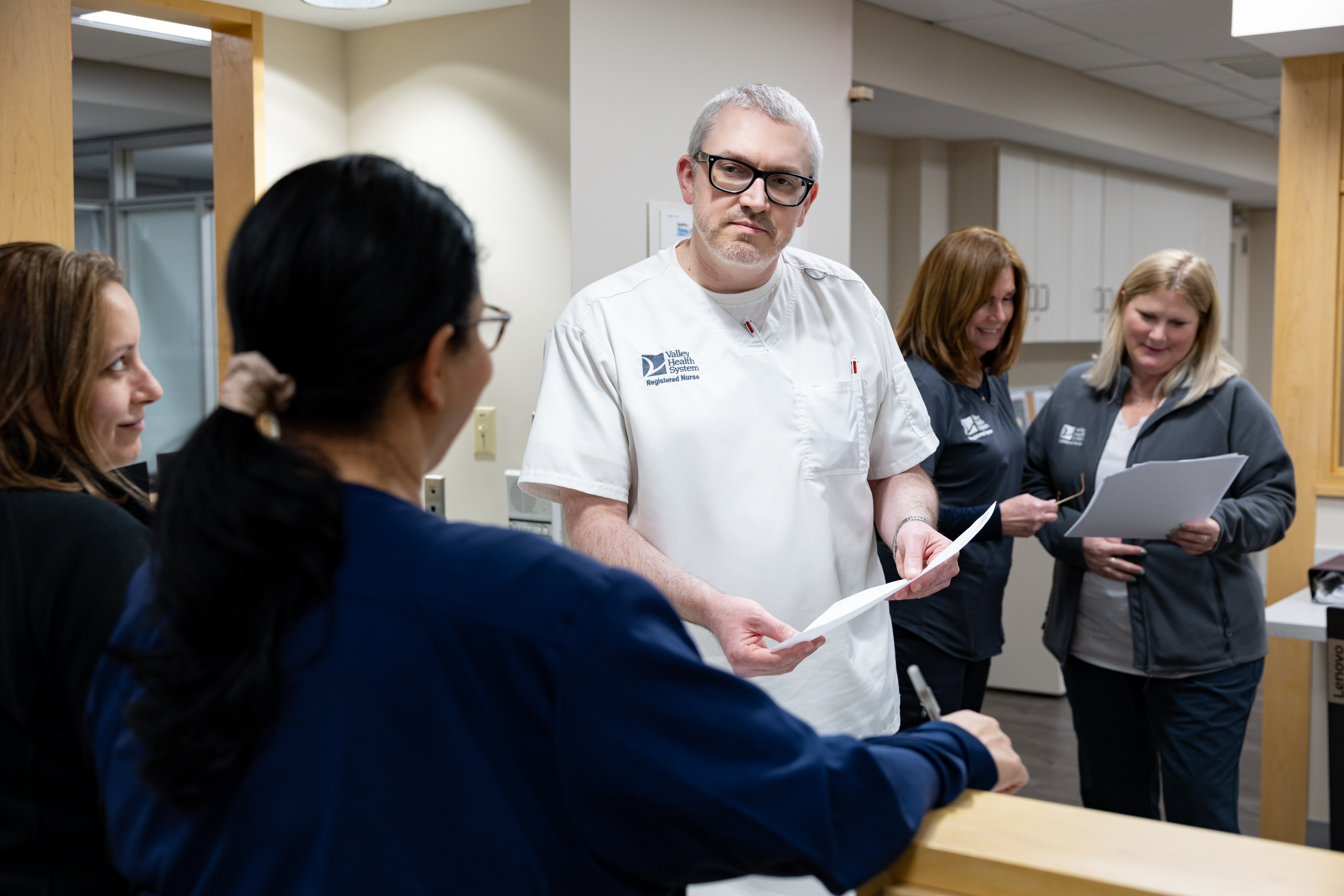 A Family Care Center nurse consulting with staff