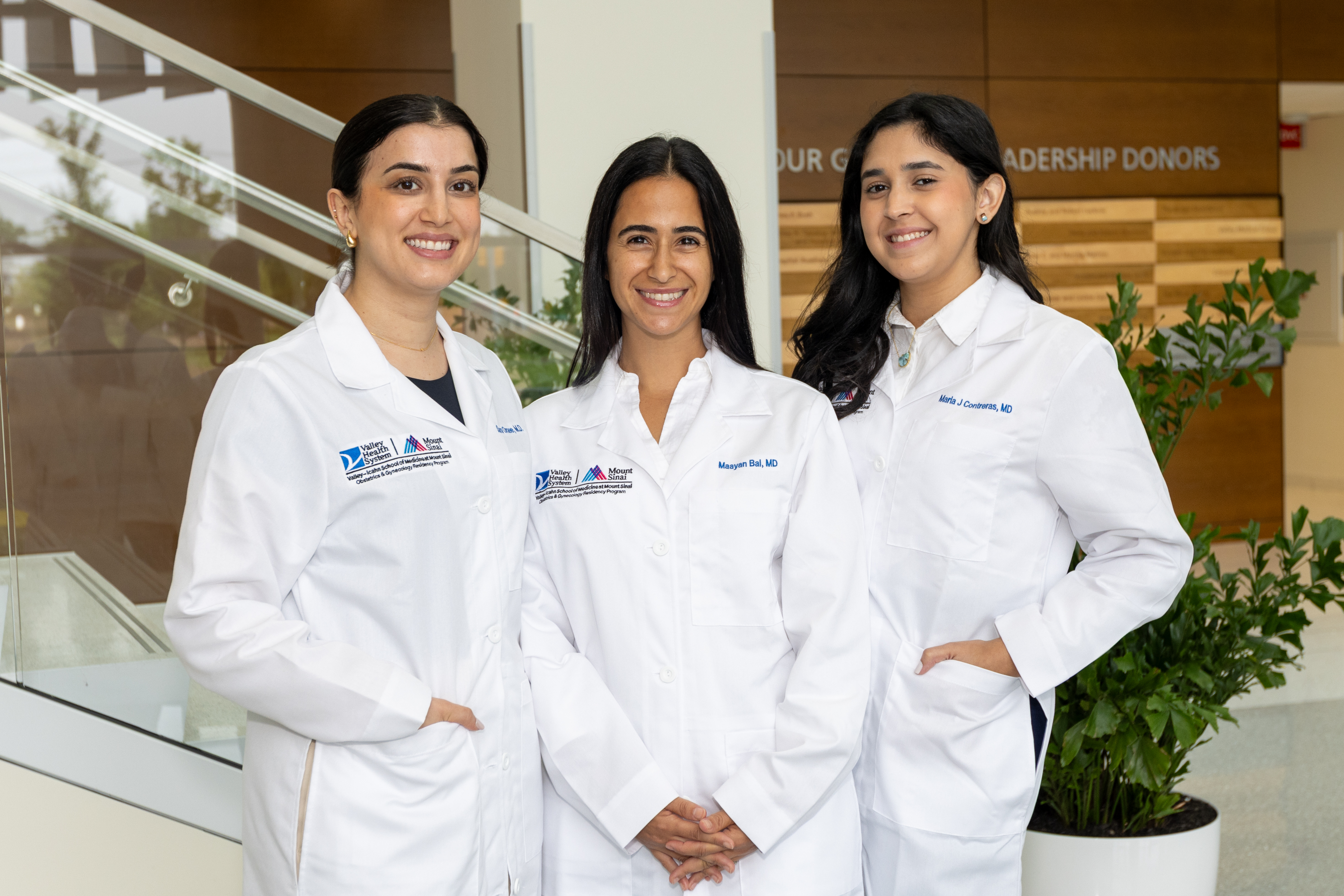 group of obgyn resident doctors standing in the lobby of a hospital