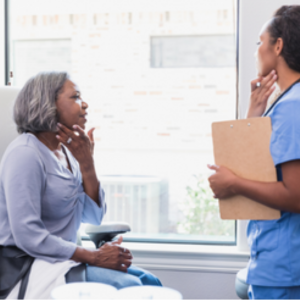 Female patient speaking to female dermatologist during a skin cancer screening.