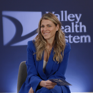 Female doctor smiling at the camera being interviewed.