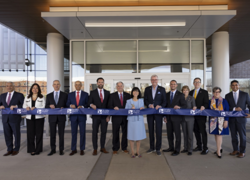 group of people cutting a ribbon