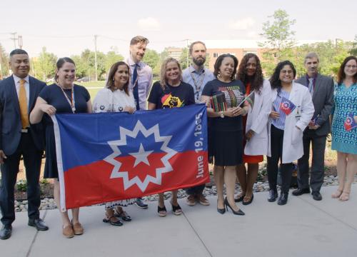 group of employees celebrating Juneteenth at flag raising ceremony
