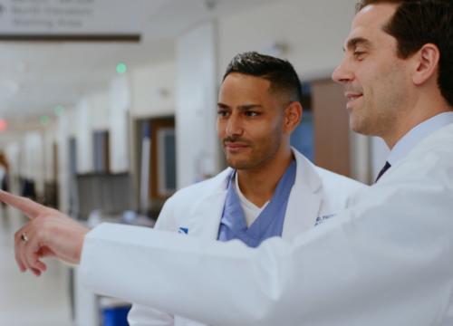 doctors talking about patient condition and looking at a screen