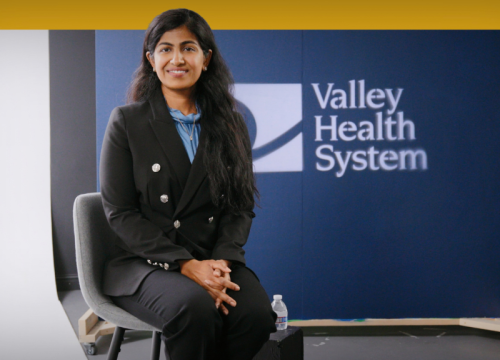 Merlyn Mathew, DO, sitting being interviewed