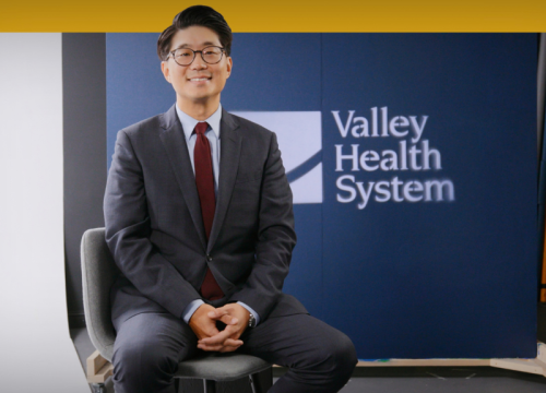 Moo Young Cho, MD sitting being interviewed
