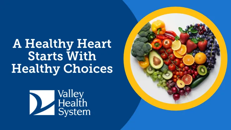 colorful fruits and vegetables arranged in the shape of a heart