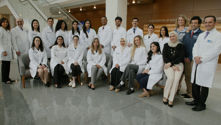 group of class of 2025 residents in lobby of hospital