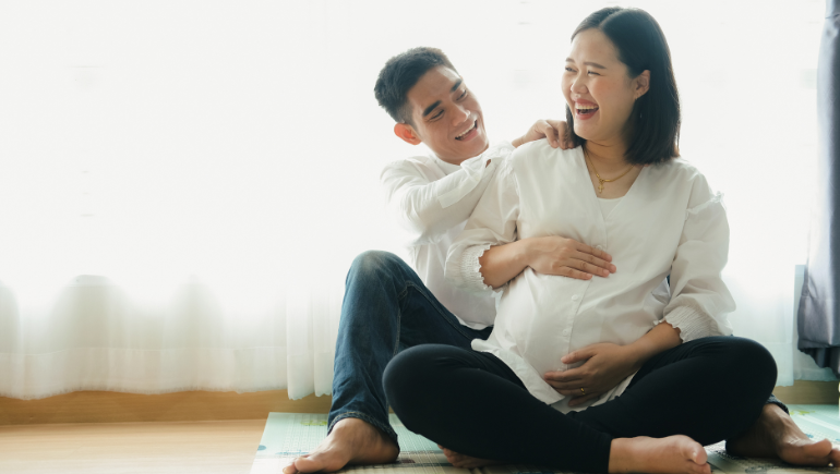 pregnant woman smiling with her partner