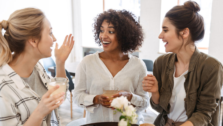 women smiling and talking together