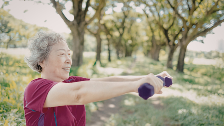 senior woman lifting weights outside