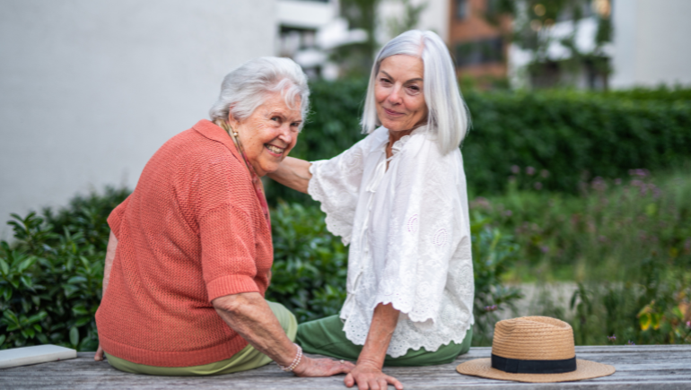 adult woman with her senior mother smiling