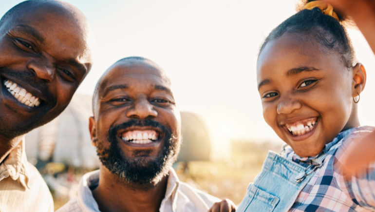 LGBTQ+ patient smiling with his family