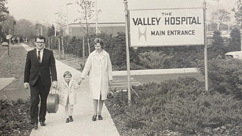 black and white photo of patients standing outside of the old valley hospital