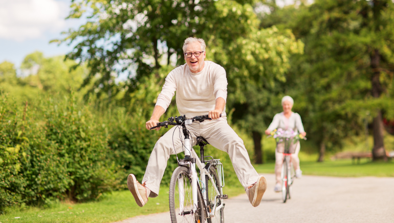 man riding bike being active, happy, and smiling