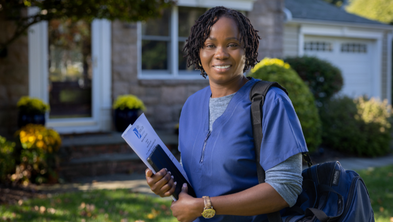 Valley Home Care nurse smiling outside a home