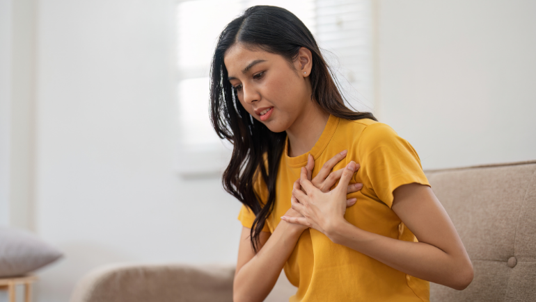 a woman touching her heart, feeling heart palpitations