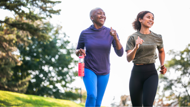 two women walking and smiling