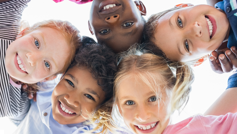 children smiling in a circle