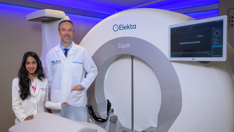 rupa juthani, md and chad deyoung, md, standing next to the esprit machine