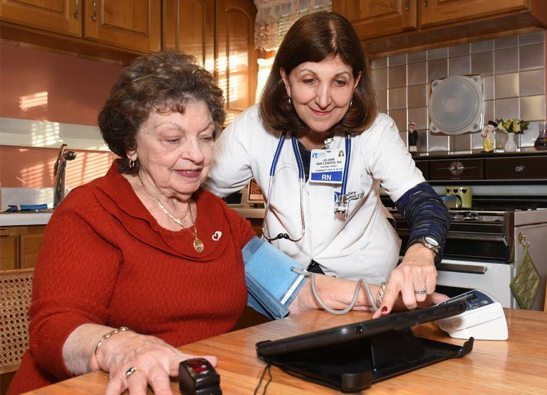 Nurse helping elderly woman