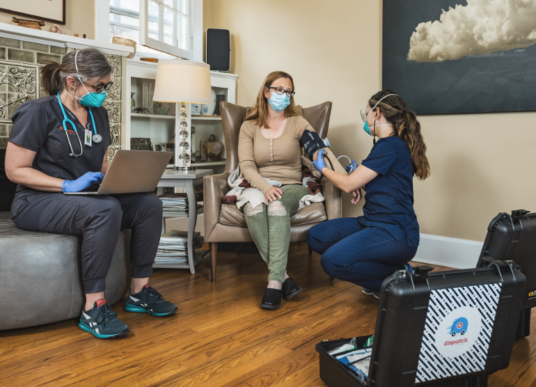 DispatchHealth providers with patient, wearing masks