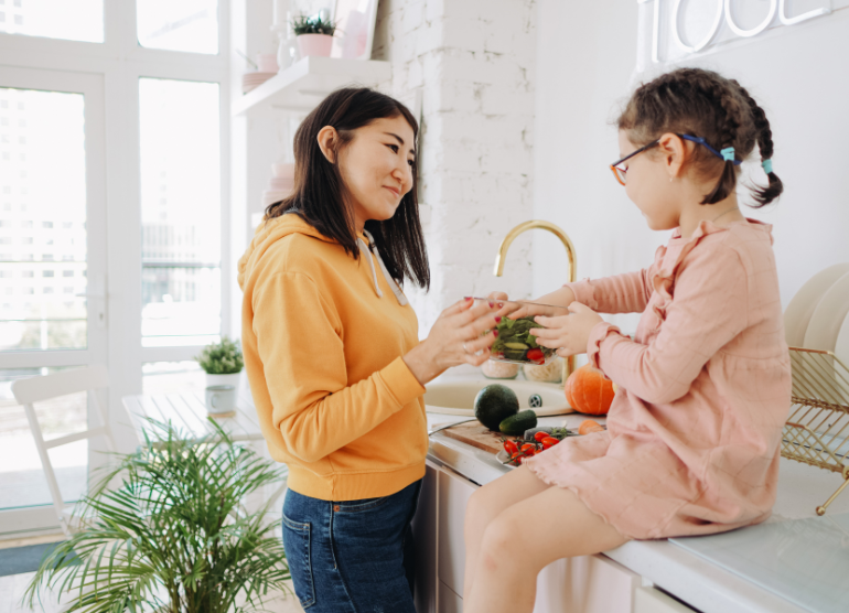 mom and daughter preparing food