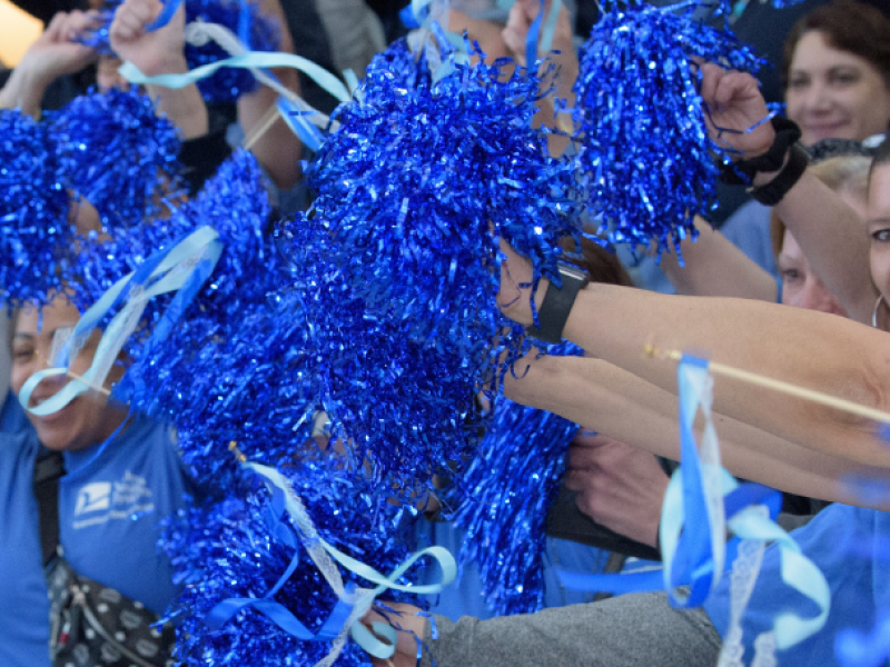 Volunteers at The Valley Hospital celebrating with blue pom-poms
