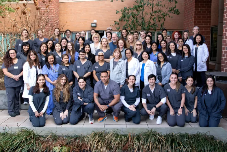 group of nurses in front of building